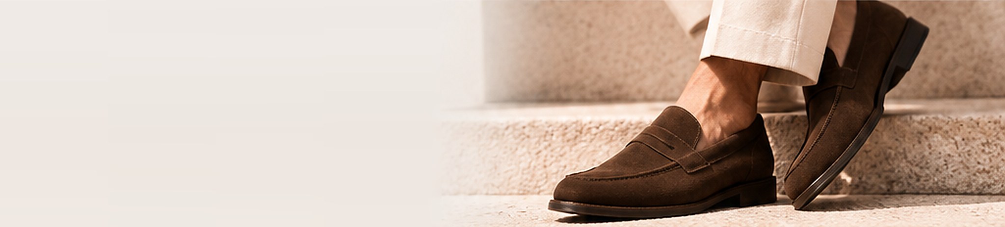Brown suede loafers worn with cream trousers
